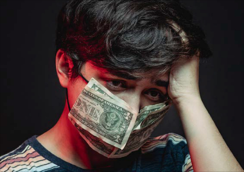 Person wearing medical-style mask made of money