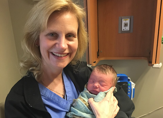 Dr. Pilkinton with a newborn Dr. Pilkinton with a newborn