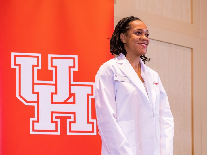 UH Tilman J. Fertitta Family College of Medicine student in white coat. UH Tilman J. Fertitta Family College of Medicine student in white coat.