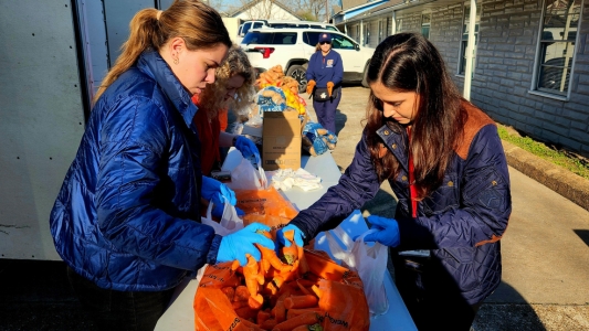 Students assist with AAMA food distribution