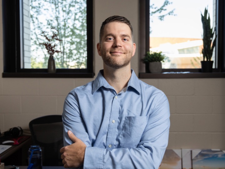 Daniel Hauptvogel standing in front of his desk