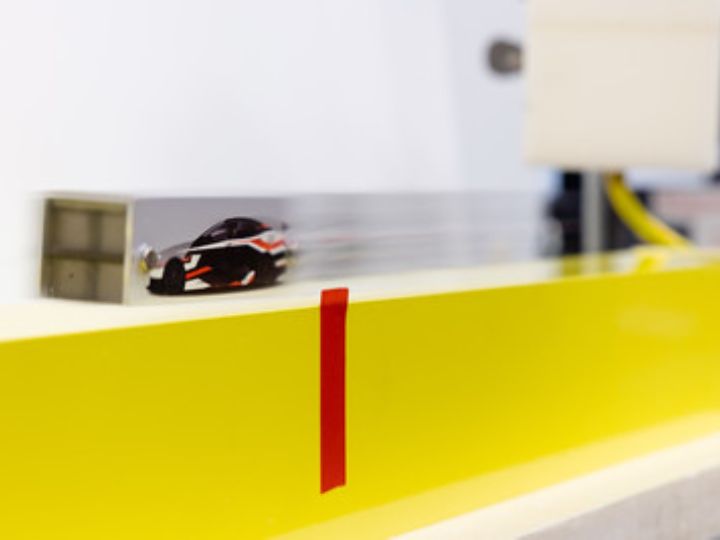 Levitated model car zooming over the lab model of the superconducting guideway in Dr. Ren's lab at the University of Houston 