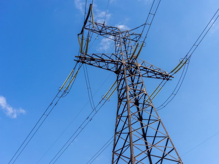 Power lines against blue sky Power lines against blue sky