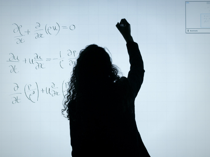 woman at white board woman at white board