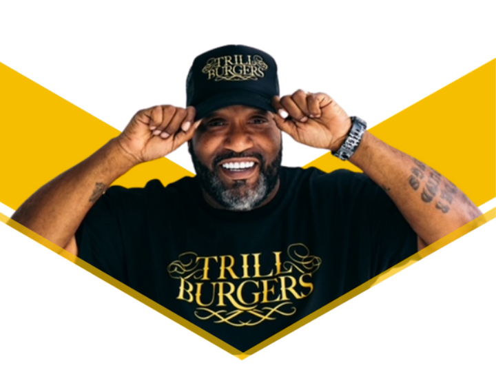 Bun B smiling and wearing a shirt that says Trill Burgers