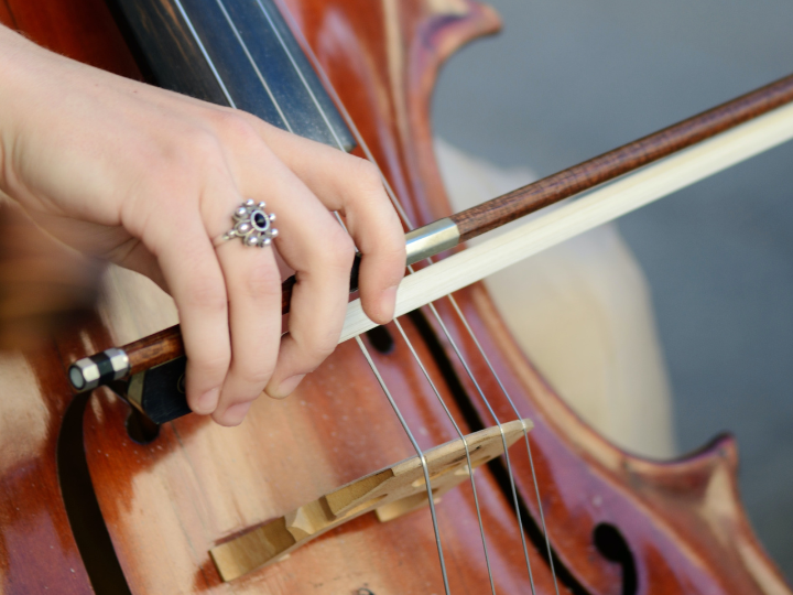 close up of woman playing the cello