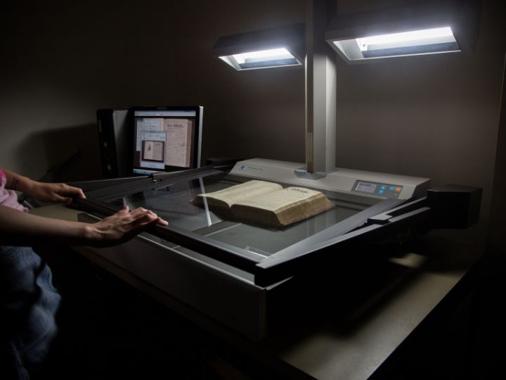 Book being scanned by machinery