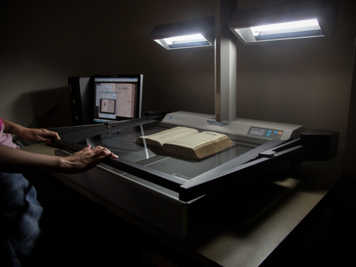 Book being scanned by machinery Book being scanned by machinery