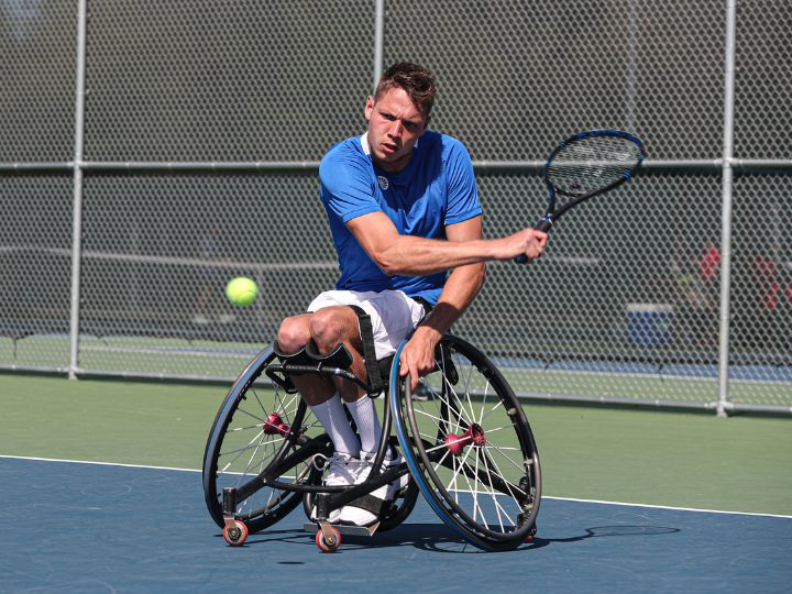 Man plays wheelchair tennis