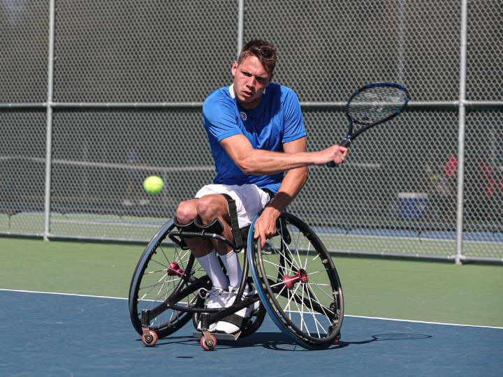 Man plays wheelchair tennis Man plays wheelchair tennis