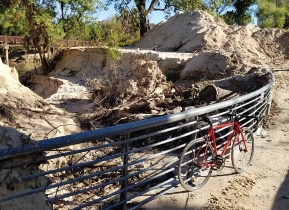Mounds of sediment on top of and surrounding banks of Buffalo Bayou Mounds of sediment on top of and surrounding banks of Buffalo Bayou