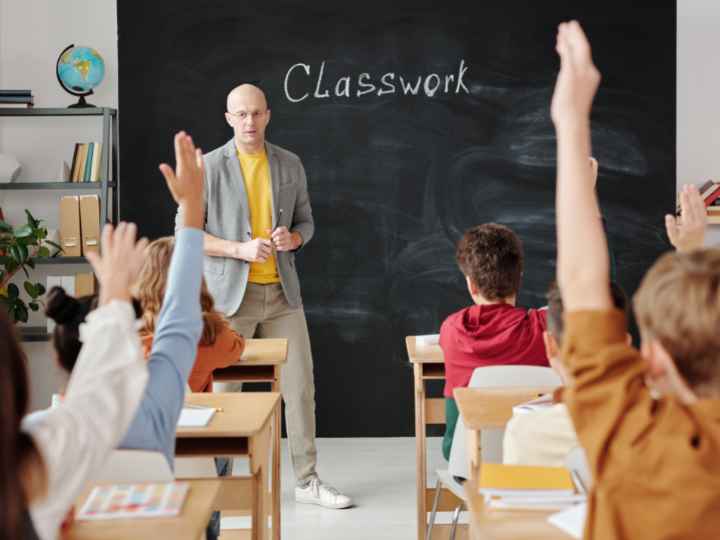 Photo of students and teacher in their classroom Photo of students and teacher in their classroom