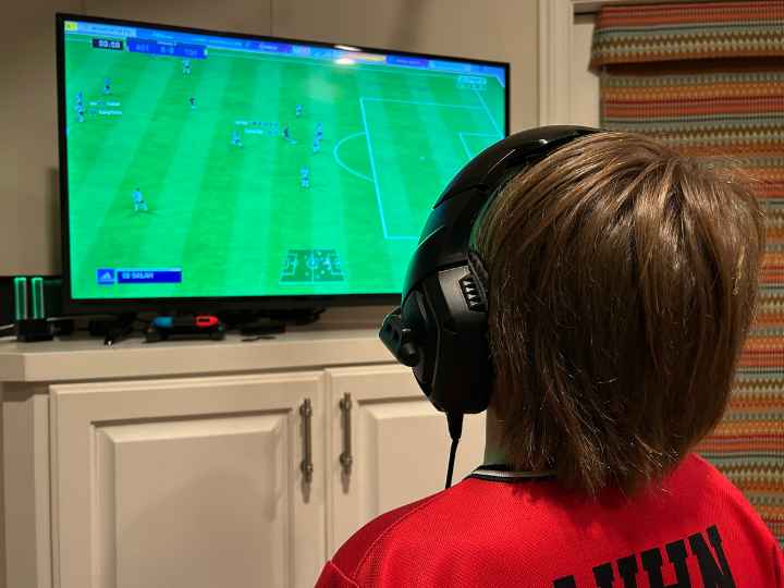Photo of young boy playing a video game Photo of young boy playing a video game