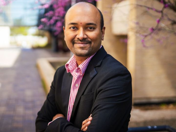 UH Professor Harish Krishnamoorthy in front of a building.