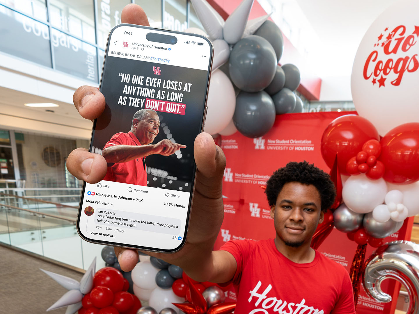 UH student holding phone with social media post.