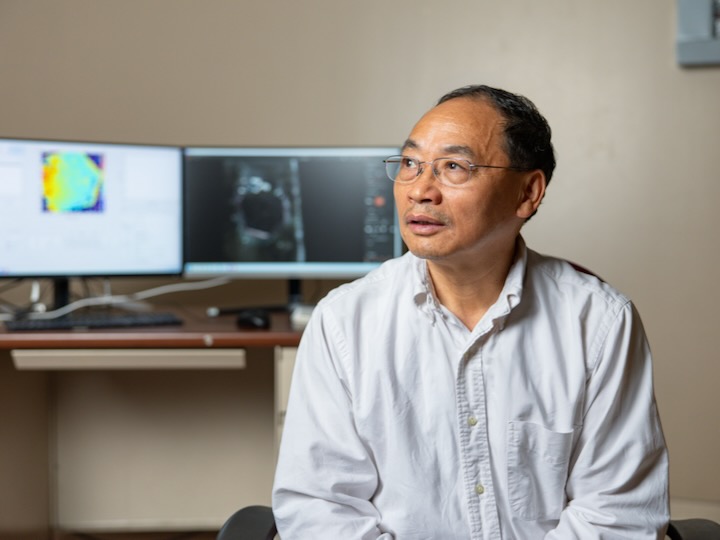 zhifeng ren poses for a photo