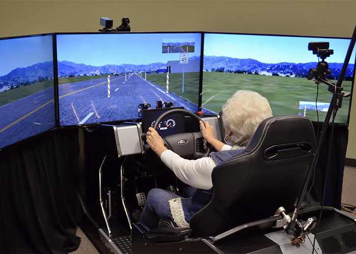 One of the 59 volunteers in a distracted driving study by the University of Houston and Texas A&M Transportation Institute sits in a high-fidelity driving simulator. (Photo credit: Malcolm Dcosta)