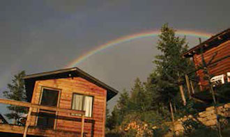 Cabins and rainbow at the YBRA Field Camp, Montana