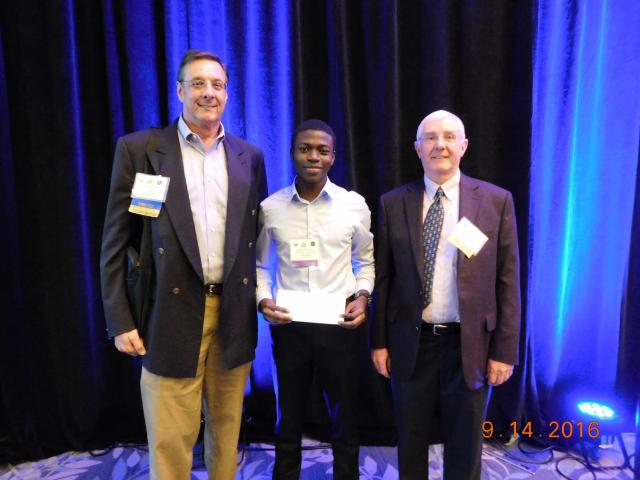 Undergraduate student Rasheed Ajala receives second place poster award from Houston Geological Society president John Jordan and president-elect John Adamick.