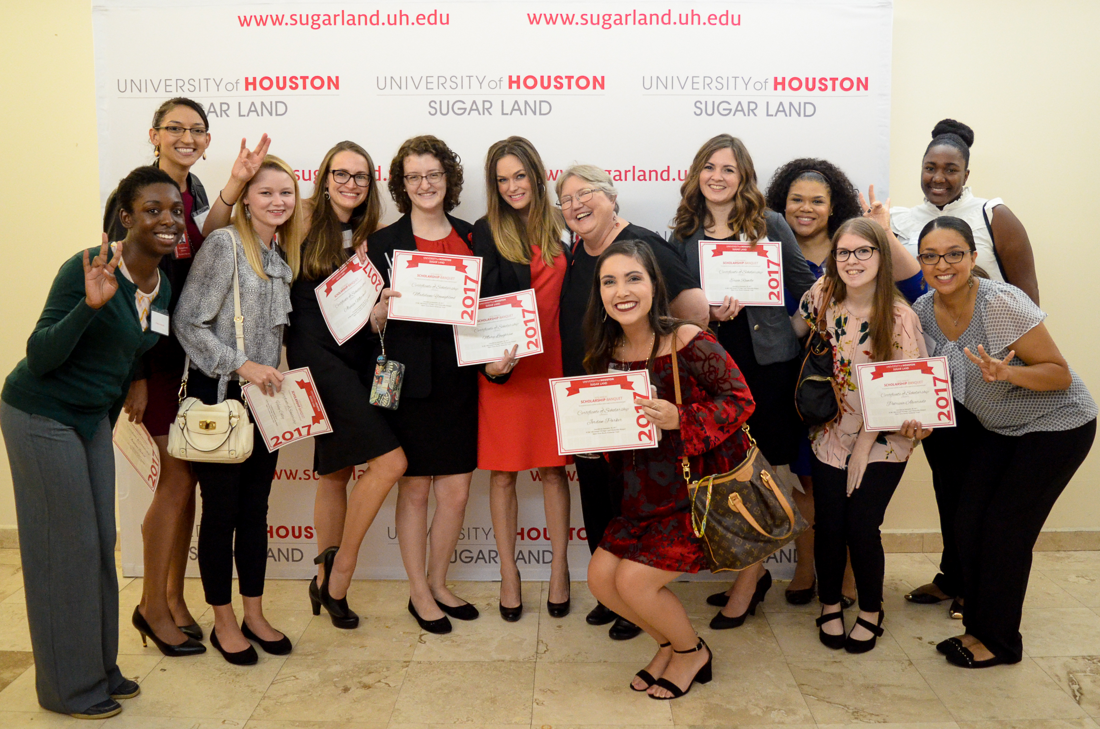 Group of students with scholarship certificates