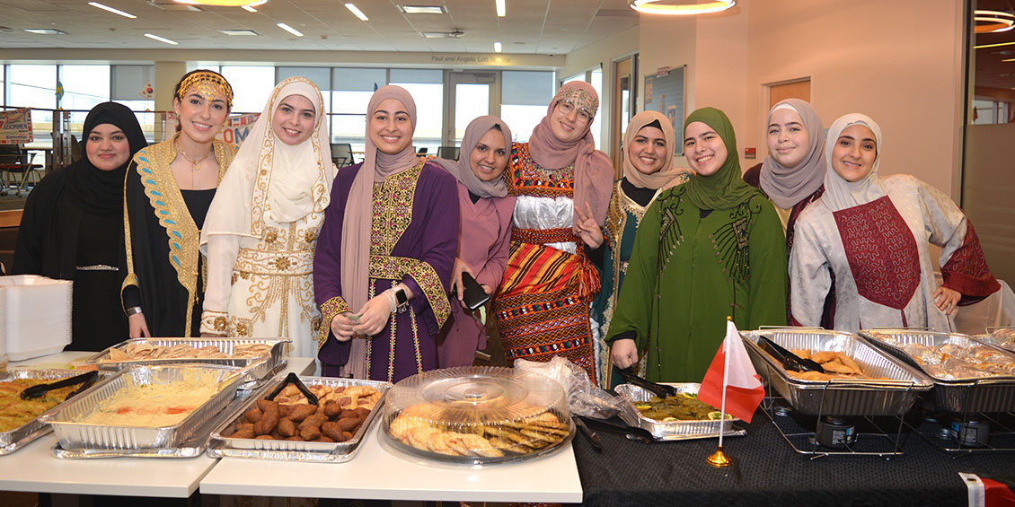 Group of students serving traditional Middle Eastern food.