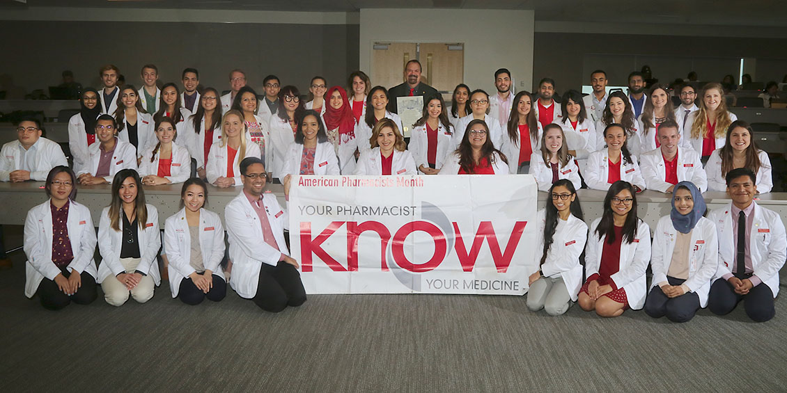 group photo of apha-aps members and banner