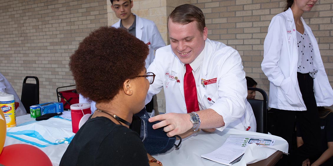 Photo of Pharm.D. student performing blood pressure screening