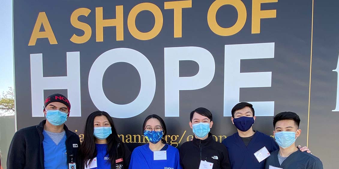 students next to memorial hermann sign