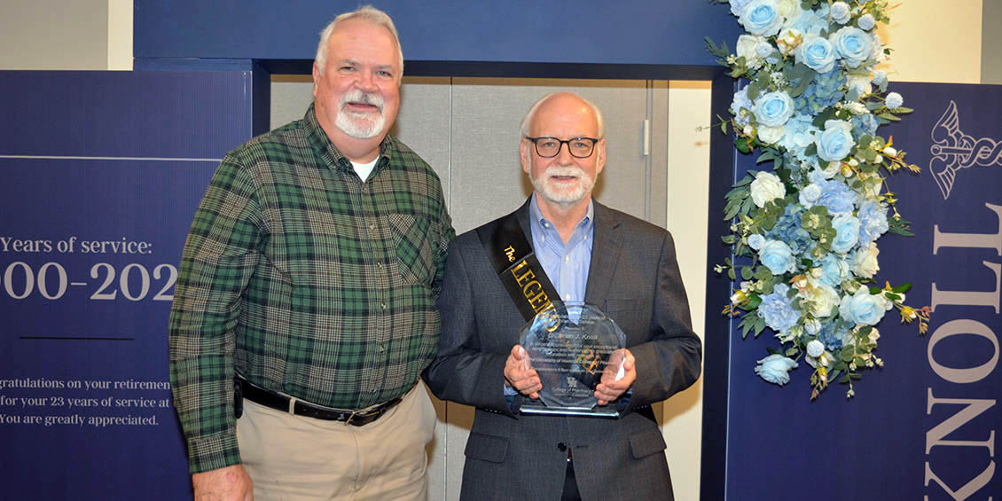 knoll receives plaque from dean pritchard