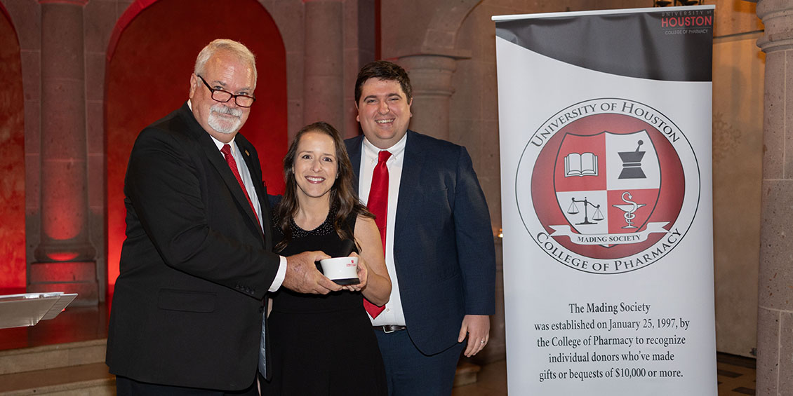 Mading Society inductees Kelly and Doug Thornton accept the mortar and pestle keepsake from Dean Pritchard.