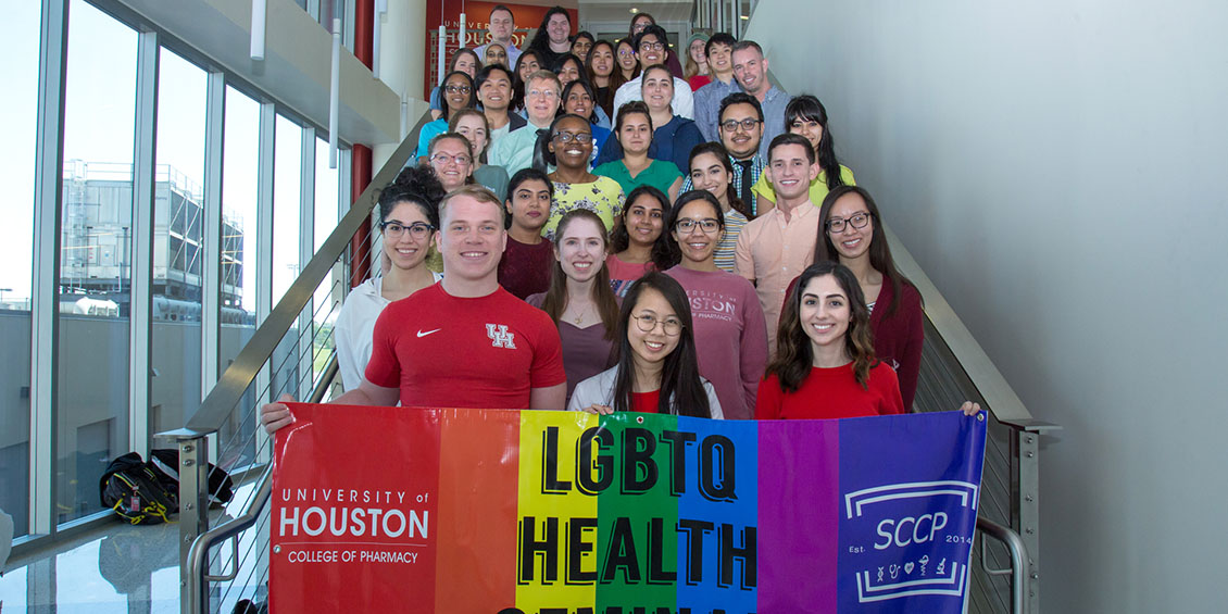 student org members with banner for lgbtq seminar