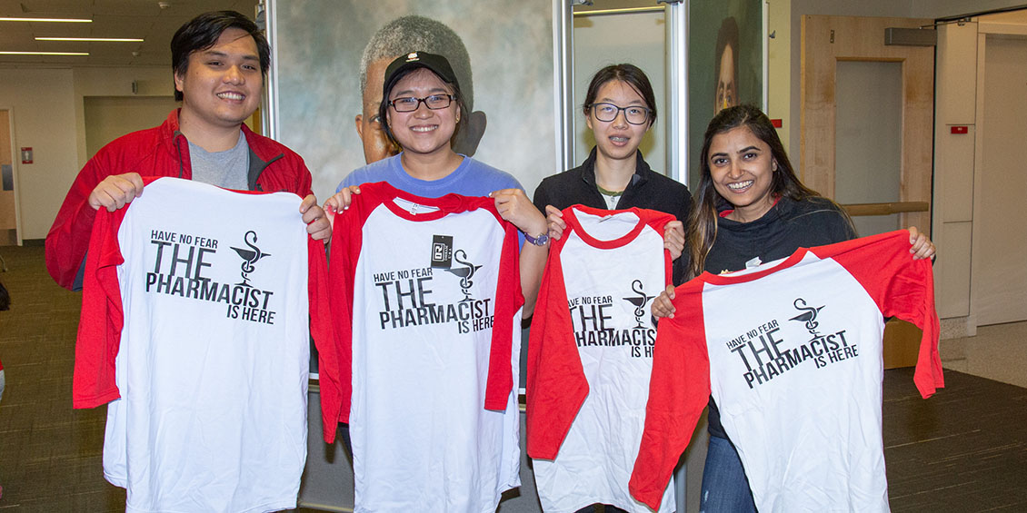 students holding t-shirts