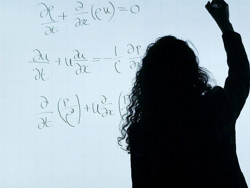 Teacher writing on board
