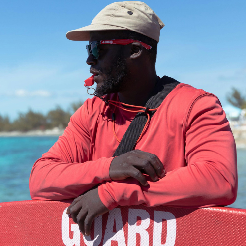 male lifeguard looking over