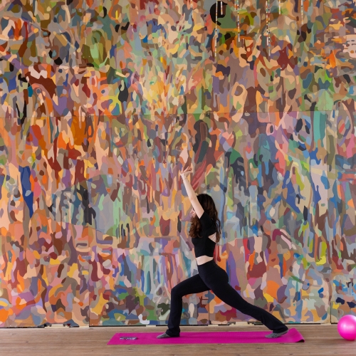 female in the yoga pose hands in the air