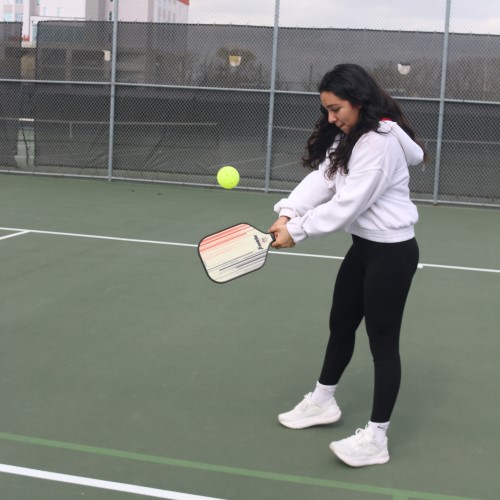 female swinging racquet pickleball