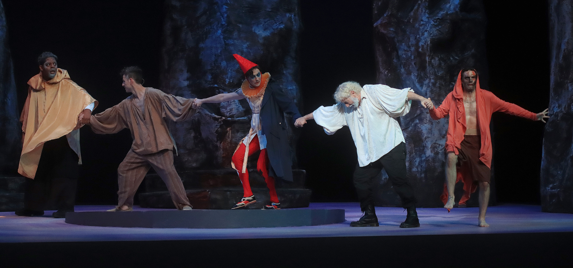 Gloucester and Kent lead the mad Lear, his bedraggled Fool, and Edgar (disguised as Mad Tom) out of the storm into shelter in HSF's 2022 production of King Lear.
