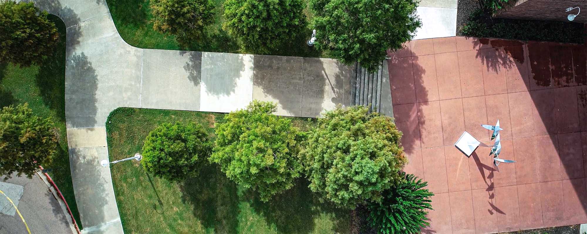 Overhead view of sidewalks and scultpure outside Brazos Hall