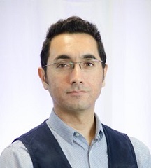 Portrait of a dark-haired man wearing glasses