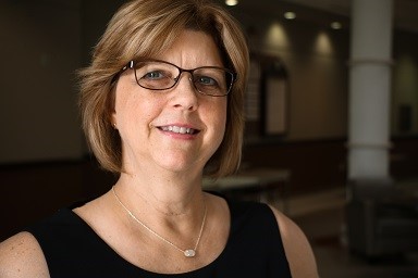 A portrait of a woman with short hair and glasses