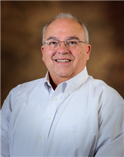 Portrait of man wearing glasses and a white dress shirt