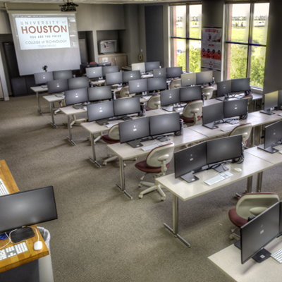Classroom with monitors and computers on the tables