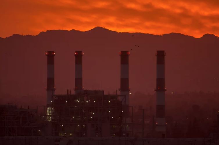 Smog over factory at sunset.