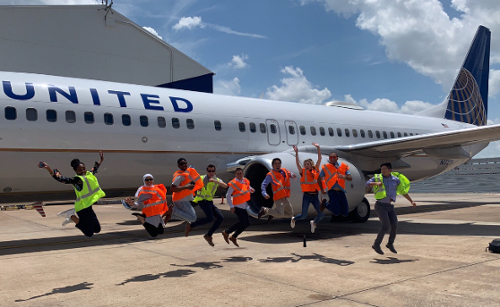 Rawan and peers in front of airplane