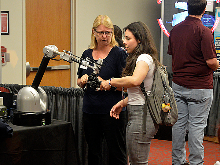 people looking at a robot people looking at a robot
