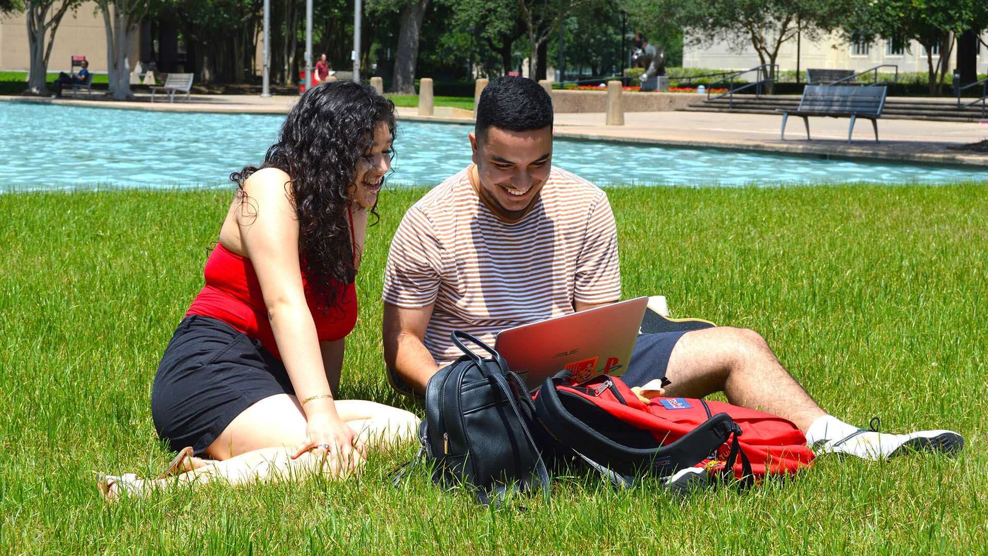 Students studying at the fountains.